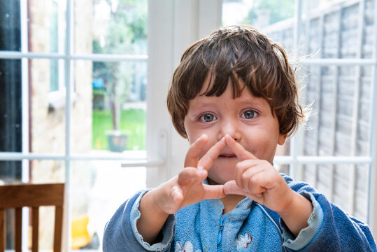 Toddler boy making shapes with his fingers
