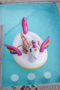 Mother and son in inflatable in pool