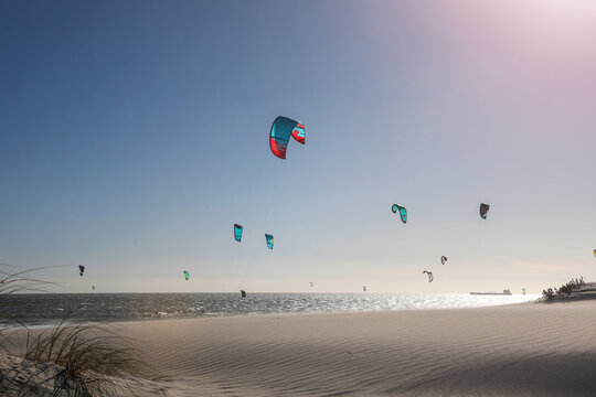 Group of kite surfers mid air over sea, Cape Town, Western Cape, South Africa