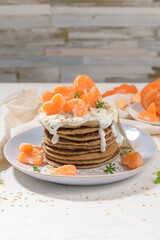 Pancakes with yogurt and tangerines