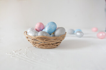 Naklejka na ściany i meble easter eggs in a basket on a white background