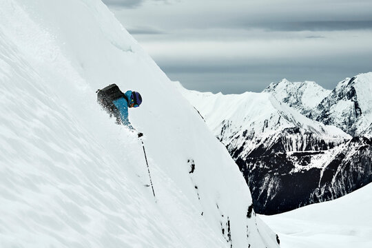 Male skier speeding down steep mountainside, Alpe-d'Huez, Rhone-Alpes, France