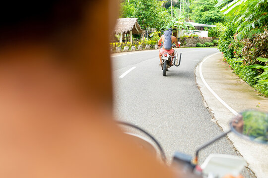 Men on motorbike road trip, Pagudpud, Ilocos Norte, Philippines