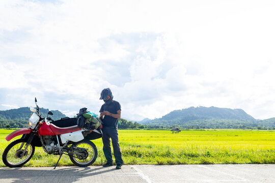 Motorcyclist stopping by roadside, Camalaniugan, Cagayan, Philippines