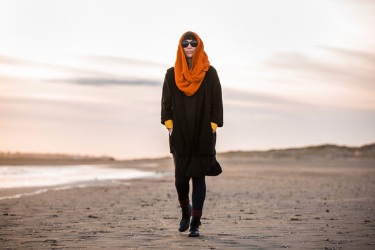 Woman walking alone on beach