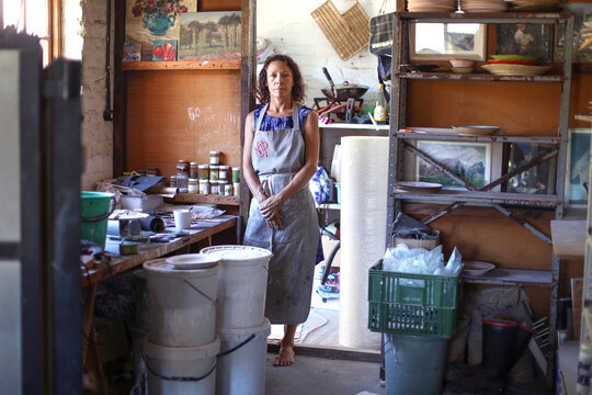 Female potter resting in workshop