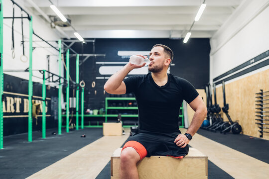 Man with disability drinking water in gym - Powered by Adobe