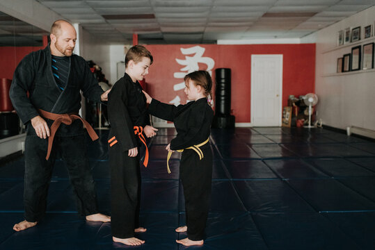 Coach and students practising martial arts in studio