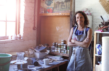 Female potter resting in workshop