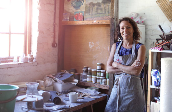 Female potter resting in workshop