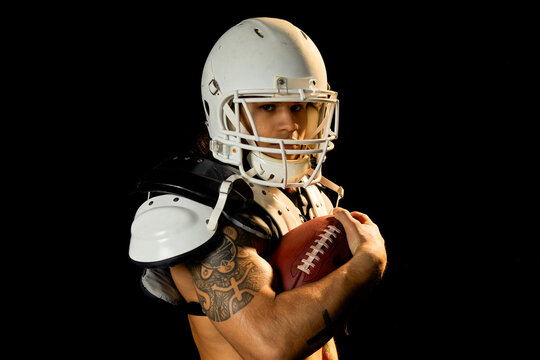 Portrait of football player, black background