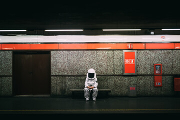 Astronaut waiting on train platform