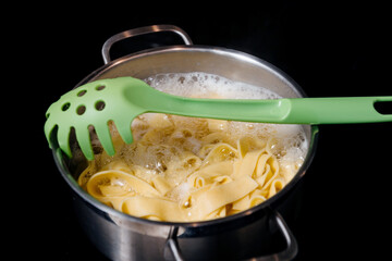 pasta in pot on the induction cooking hob