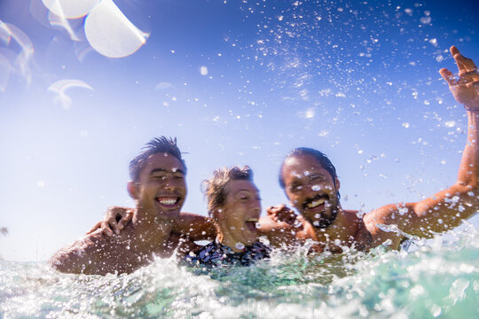 Friends splashing in sea, Pagudpud, Ilocos Norte, Philippines