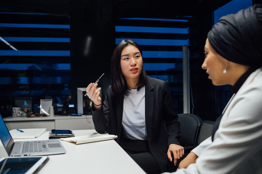 Businesswomen having discussion during conference table meeting