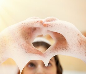 Naklejka premium bath foam. baby hands in bubble bath, baby washing in bubble bath