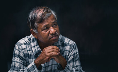 Portrait of Asian sad senior man in studio shot.