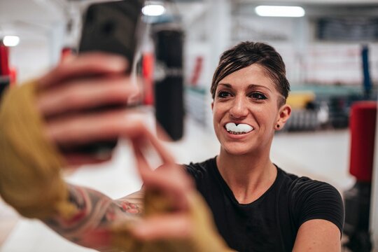 Boxer taking selfie wearing gumshield in gym