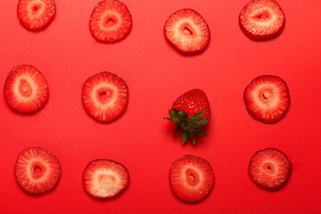 pattern of cut strawberries on a red background