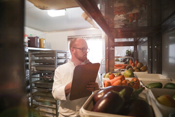 Chef checking stock of goods in storage room
