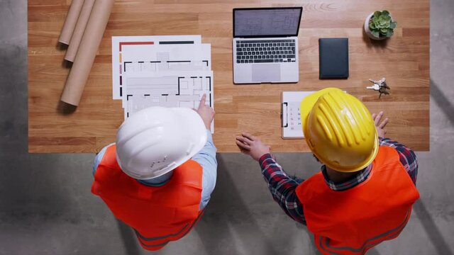 Top view of two architects discussing about project. Copy space.