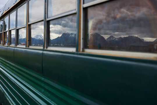 Reflection of mountain ranges on windows of mobile home bus, Homer, Alaska, United States