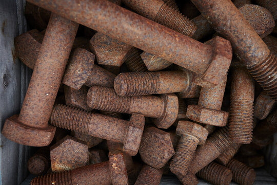 Rusty bolts on construction site, overhead close up
