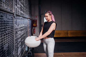 Young woman powdering palms in gym