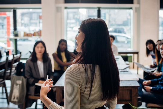 Young businesswoman doing presentation for colleagues