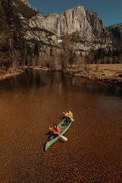 Young canoeing couple canoeing on river, high angle view, Yosemite Village, California, USA