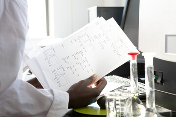 Young female scientist looking at results in laboratory, cropped