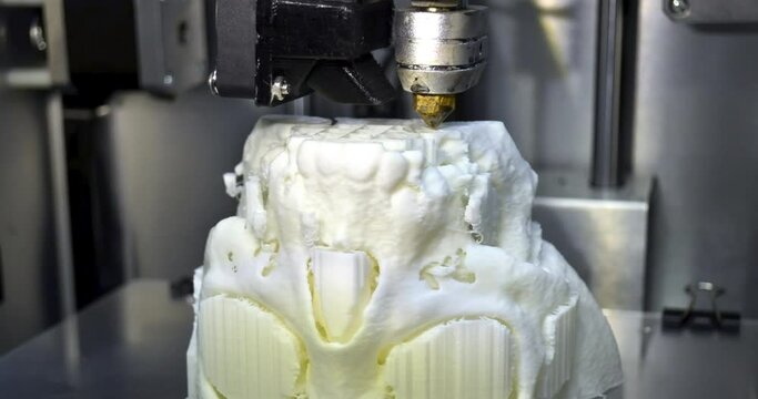 3D printer prints the form of molten plastic white close-up