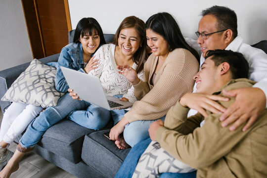 hispanic family in a video conference on laptop at home in Mexico