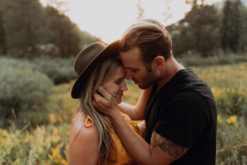 Romantic mid adult couple face to face in rural valley, Mineral King, California, USA