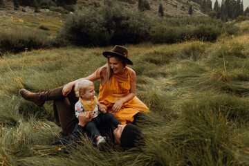 Female toddler playing with mid adult parents in rural valley, Mineral King, California, USA