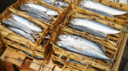 Pindang fish (salted fish) in a bamboo container at the traditional market