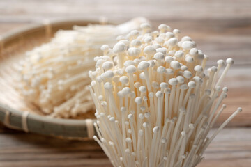 Enoki mushrooms placed on a wooden background