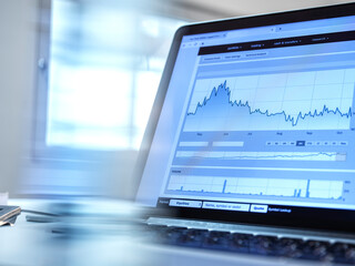 Performance of investments, share price data from a investors portfolio on a laptop computer screen.