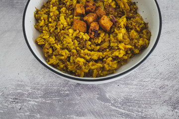 vegan lentil pilaf rice with turmeric and chinese spices topped with marinated tofu cubes, healthy plant-based food