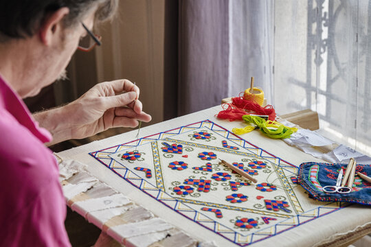 Craftsman busy with needlework indoors, &Icirc;le-de-France, Paris