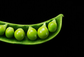 Snap peas placed on a black background