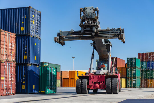 Reach stacker and shipping containers in dock