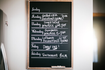 Week's meal and activity schedule written on blackboard