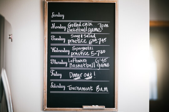 Week's meal and activity schedule written on blackboard