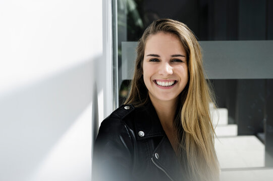 Female student taking break at corridor in campus