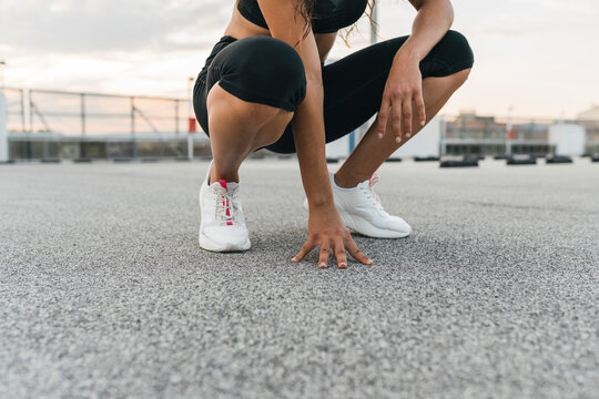 Woman squatting on rooftop deck