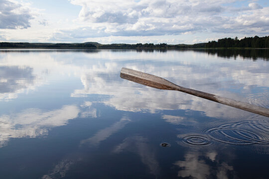 Oar, reflection of cloudscape in lake, Finland