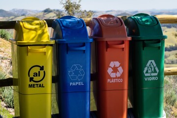 Plastic waste containers used to segregate metals, papers, plastic and glass materials for...