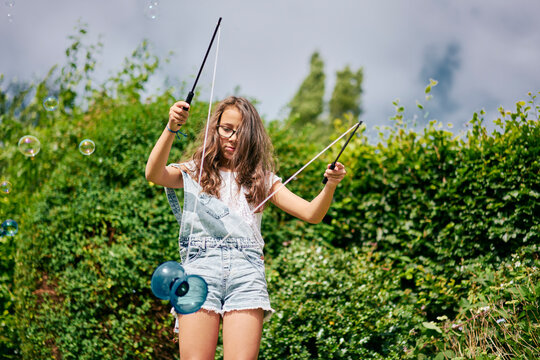  Girl playing with diabolo in garden