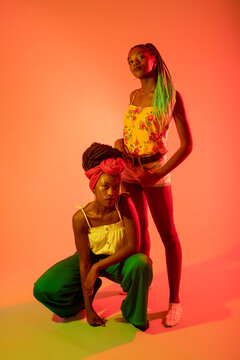 Friends posing against orange background